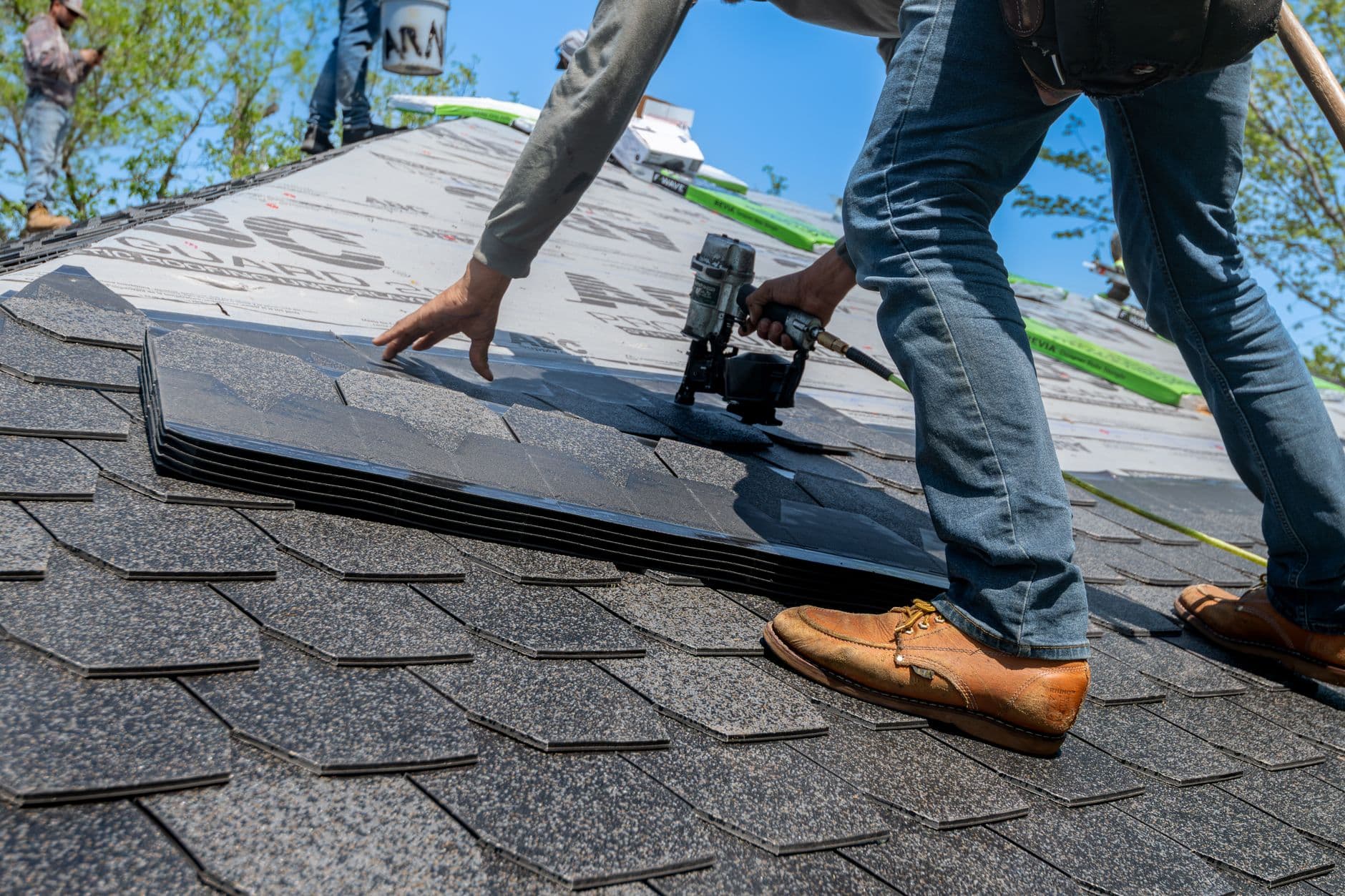 Roofer installing new shingles during a repair