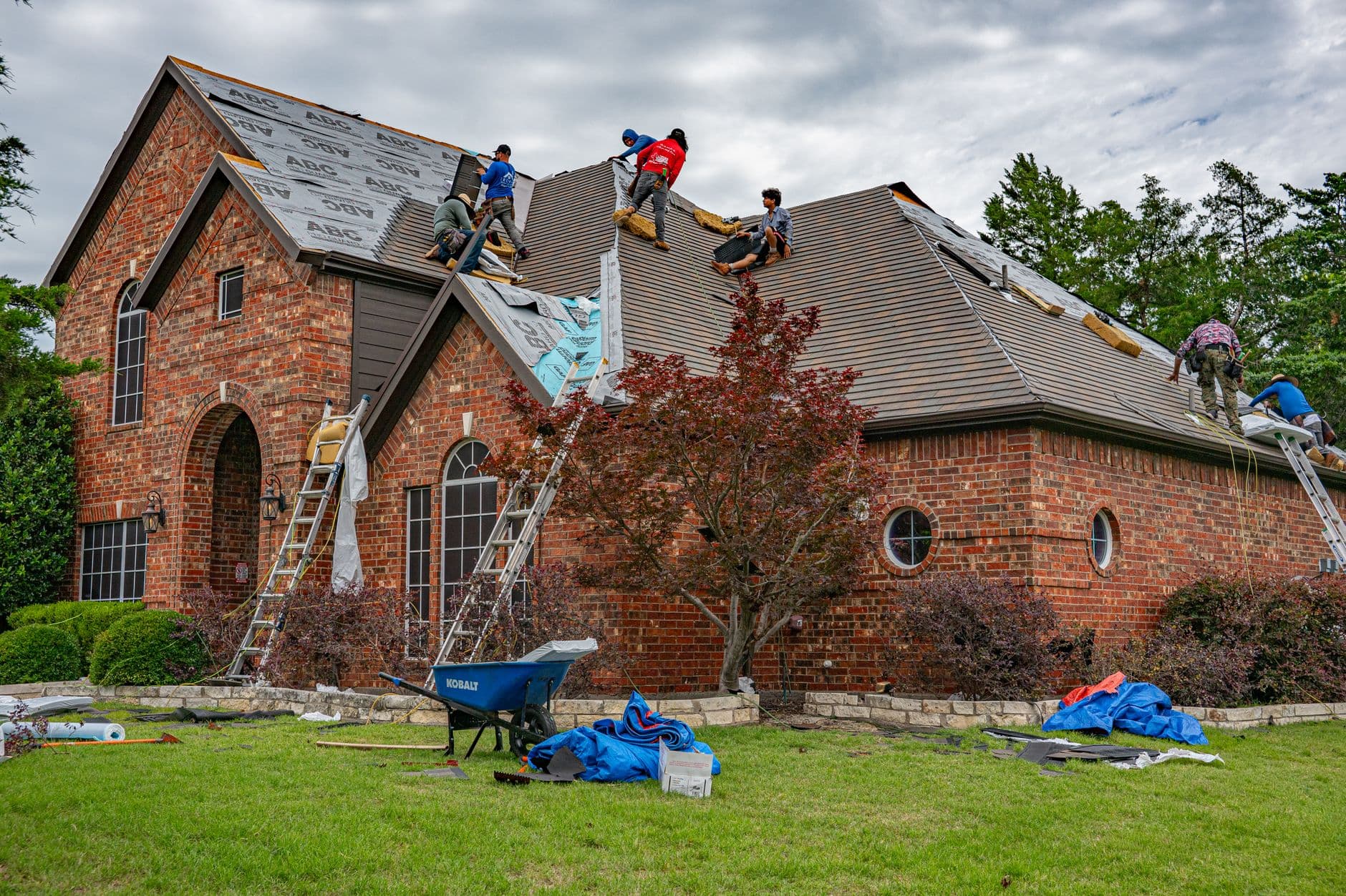 Roofing professionals working on a residential roof